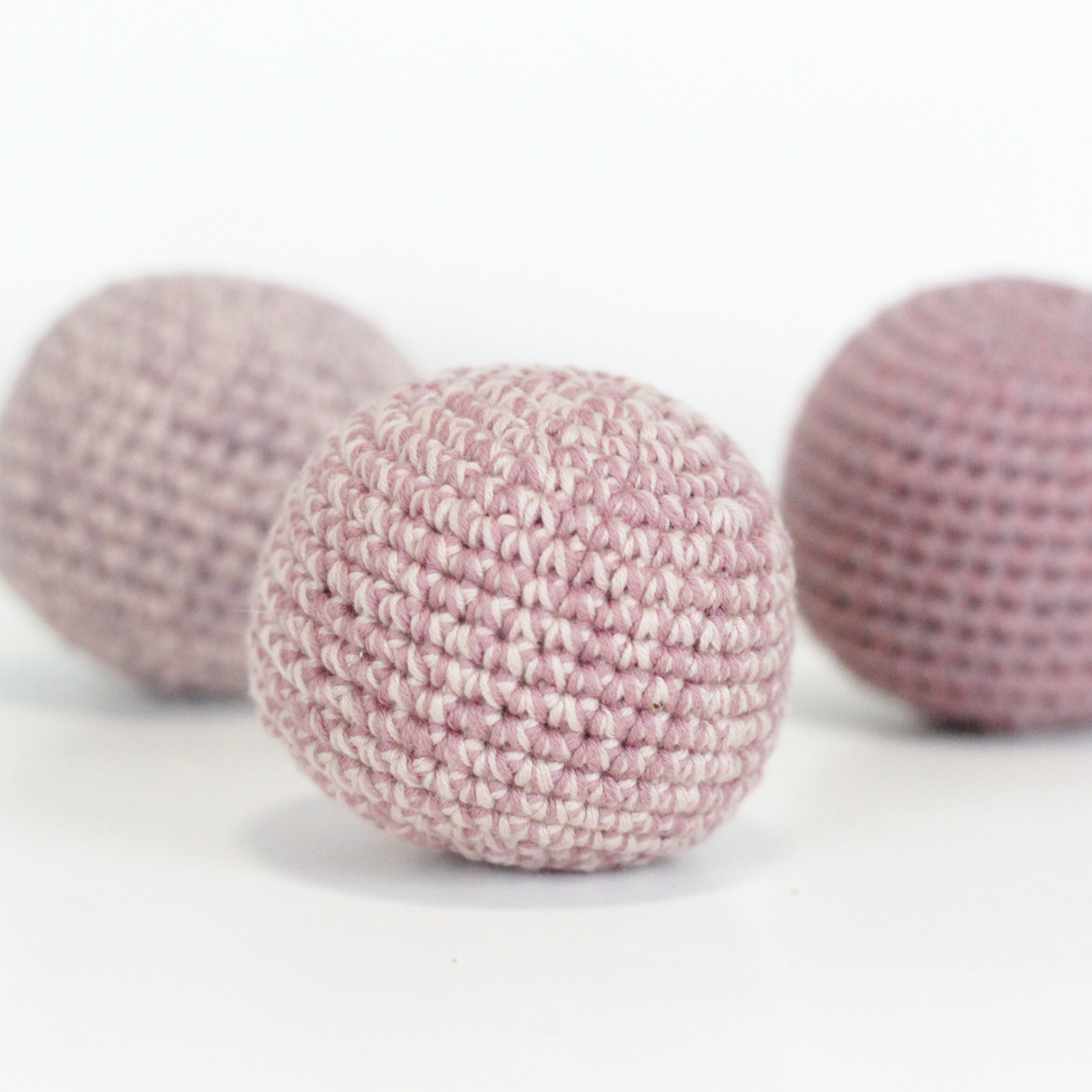 Three pink crochet balls. Handmade crochet dog toys from Lana Royals Pet Wear.