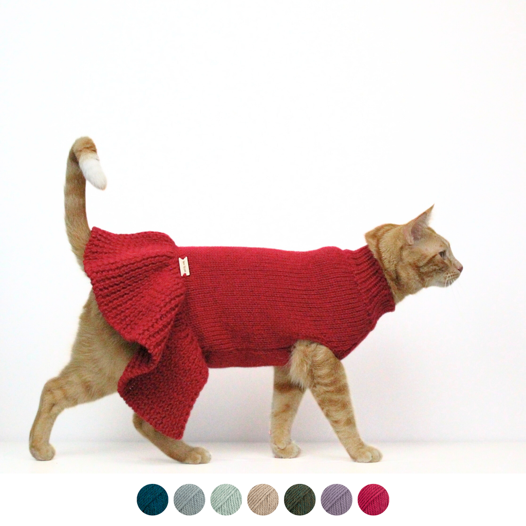 Ginger cat wearing a red hand-knitted alpaca wool sweater dress, custom-tailored to measure by Lana Royals Pet Wear.
